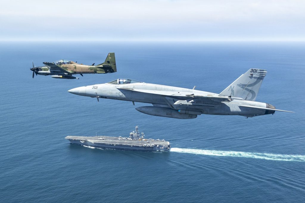 A-29 Super Tucano do Equador e F/A-18E Super Hornet da Marinha dos EUA sobrevoam o USS Nimtz durante a Southern Seas 2026. (Foto: tenente William “Simple Will” Shortal/Marinha dos EUA/Divulgação)